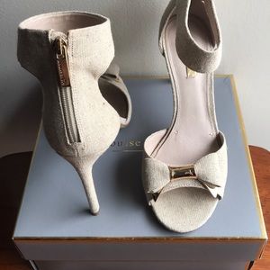 Beige canvas pump with zip up ankle strap